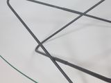 a glass table with a metal frame and a glass top