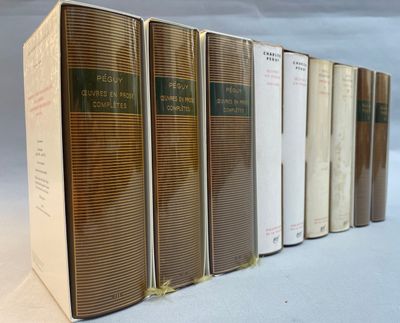 several books are lined up in a row on a white surface