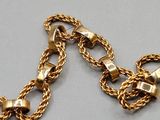 an image of a gold chain bracelet with a clasp on it