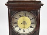 an image of a wooden clock with roman numerals on the face