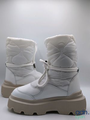 the white boots are lined up and ready to be worn
