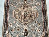 a rug with a pattern of flowers and leaves on a blue ground