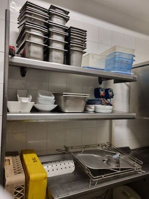 a kitchen with a lot of dishes on the shelves