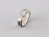 a close up of a silver ring with a black leather band