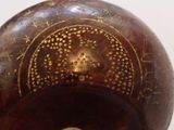 a brown vase with a gold design on it