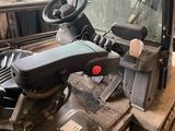 a forklift that is sitting on a pallet in a warehouse