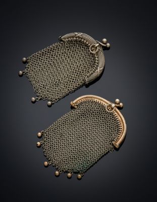 two antique mesh purses on a black background