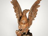 an image of a statue of a bird on a wooden base