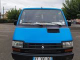 a blue van that is parked in a parking lot