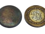 two pieces of metal with a gold and green design on them
