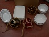 de nombreux bols et assiettes posés par terre à côté d'un carton