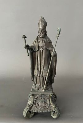 an image of a statue of a priest holding a staff