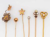several different types of hair pins are arranged on a white surface