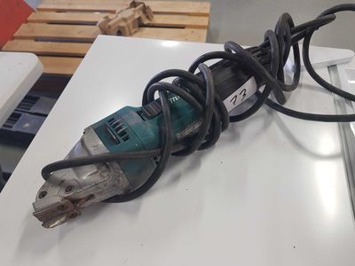 an image of a corded electric tool on a table