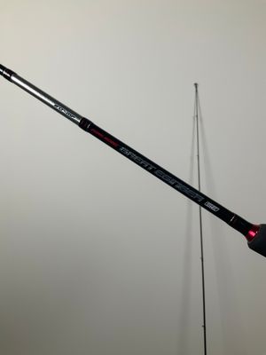 a close up of a person holding a fishing rod in their hand