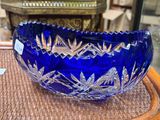un saladier en verre bleu posé sur une table en bois