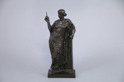 a bronze statue of a woman holding a cigarette in her hand