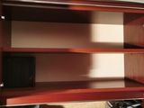 a wooden shelf with a television on top of it