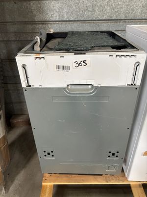 a white dishwasher sitting on top of a wooden stand