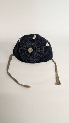 an image of a black purse with a flower on it