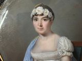 portrait of a woman in a white dress and a blue shawl