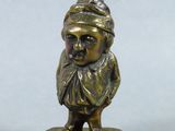 brass figurine of a man with a hat and scarf