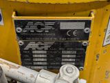 a close up view of a yellow machine with a sign on it