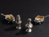 silver plated salt and pepper shakers on a black background