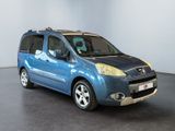 the small blue van is parked in a large room