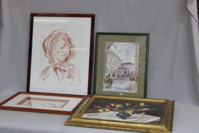 deux photos encadrées représentant une femme et un vase de fleurs posés sur une table