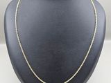 un collier à chaîne en or sur un présentoir à mannequin