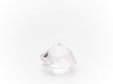 a close up of a clear diamond on a white surface