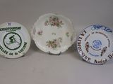 three plates with different designs on them sitting on a table