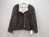 the jacket is hanging on a hanger on the wall