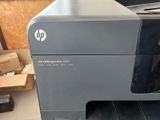a printer sitting on top of a desk in a room