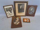 four framed pictures of people and a dog are sitting on a table