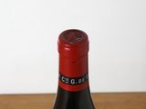 a bottle of wine sitting on a wooden table