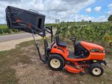 a tractor with a trailer attached to it parked in a field
