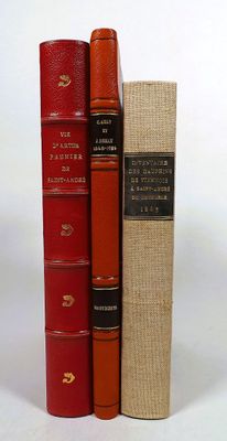 three books sitting on top of each other on a white surface