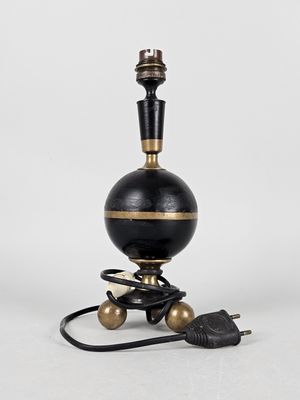 a black and gold table lamp with a cord attached to it