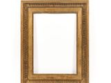 an antique gold frame with a decorative pattern on a white background