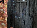 an image of a black jacket hanging on a hanger