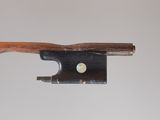 an old violin bow with a wooden handle on a white background