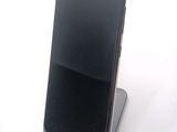 a cell phone that is sitting on top of a stand