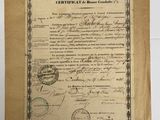 an old document with a stamp on it sitting on top of a table