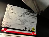 a label on the back of a laptop that is sitting on a table