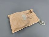 a small bag with a tag on it sitting on a table