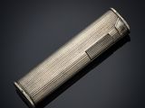 a silver cigarette case on a black background