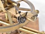 a close up of a brass sexet on a wooden stand