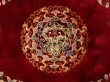 a red area rug with a floral design on it